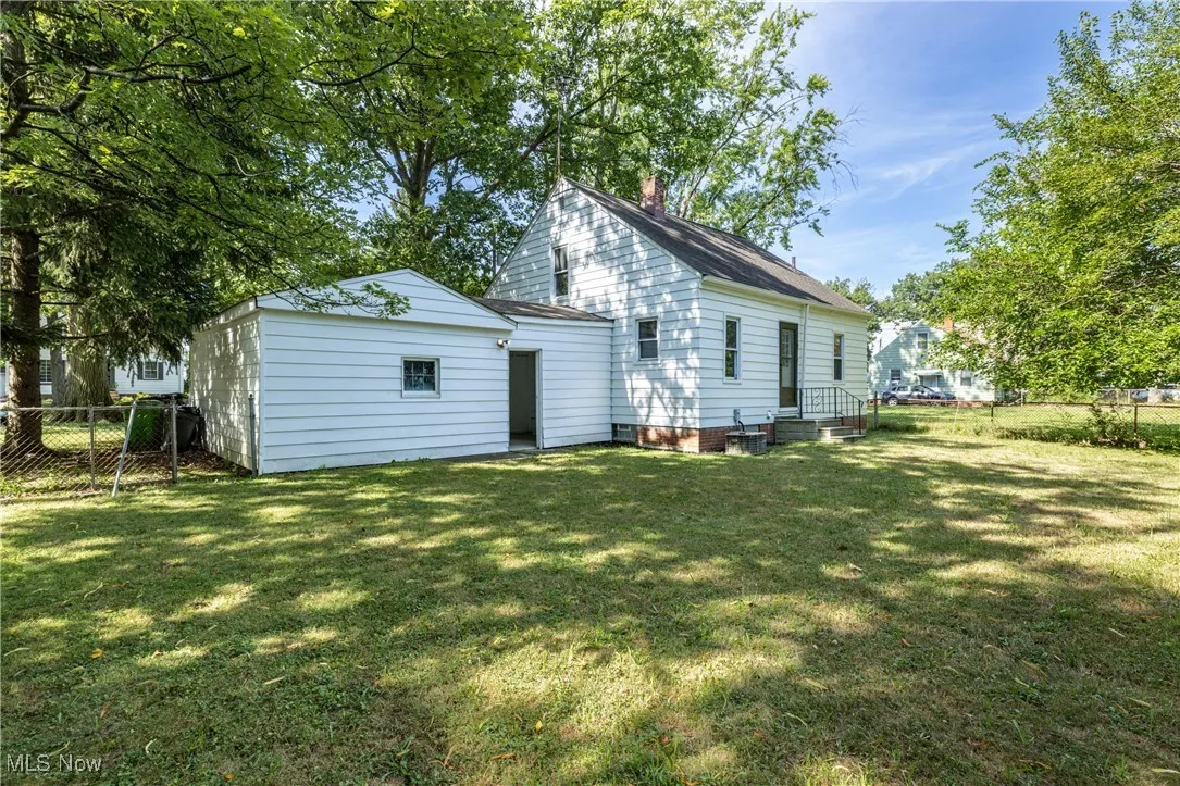Rear view of property featuring a chimney