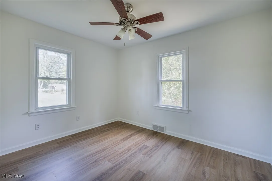 Spare room featuring wood finished floors and a ceiling fan