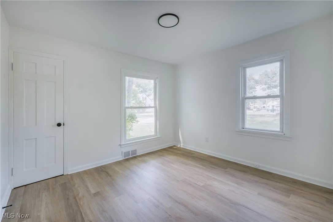 Spare room featuring wood finished floors and baseboards