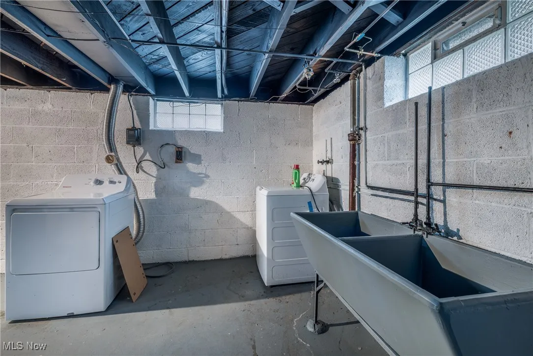 Basement with separate washer and dryer and a sink