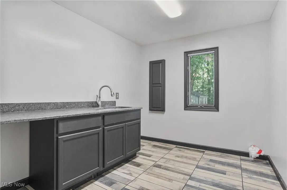 Kitchen with baseboards and a sink