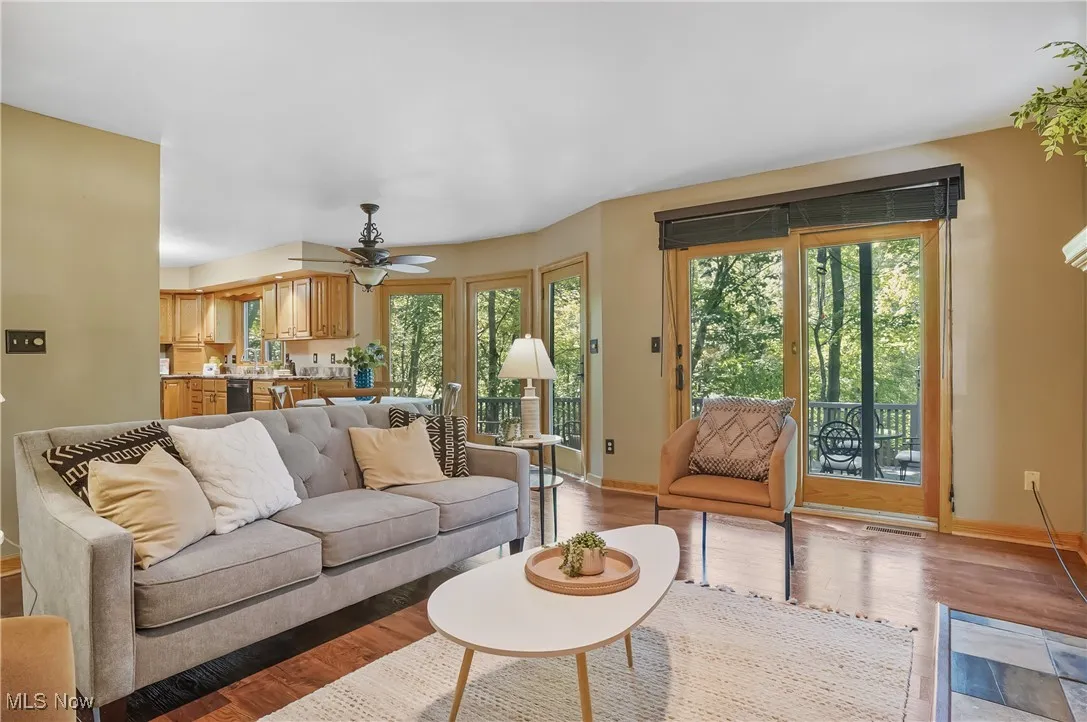 Living room with light wood-style floors and a ceiling fan