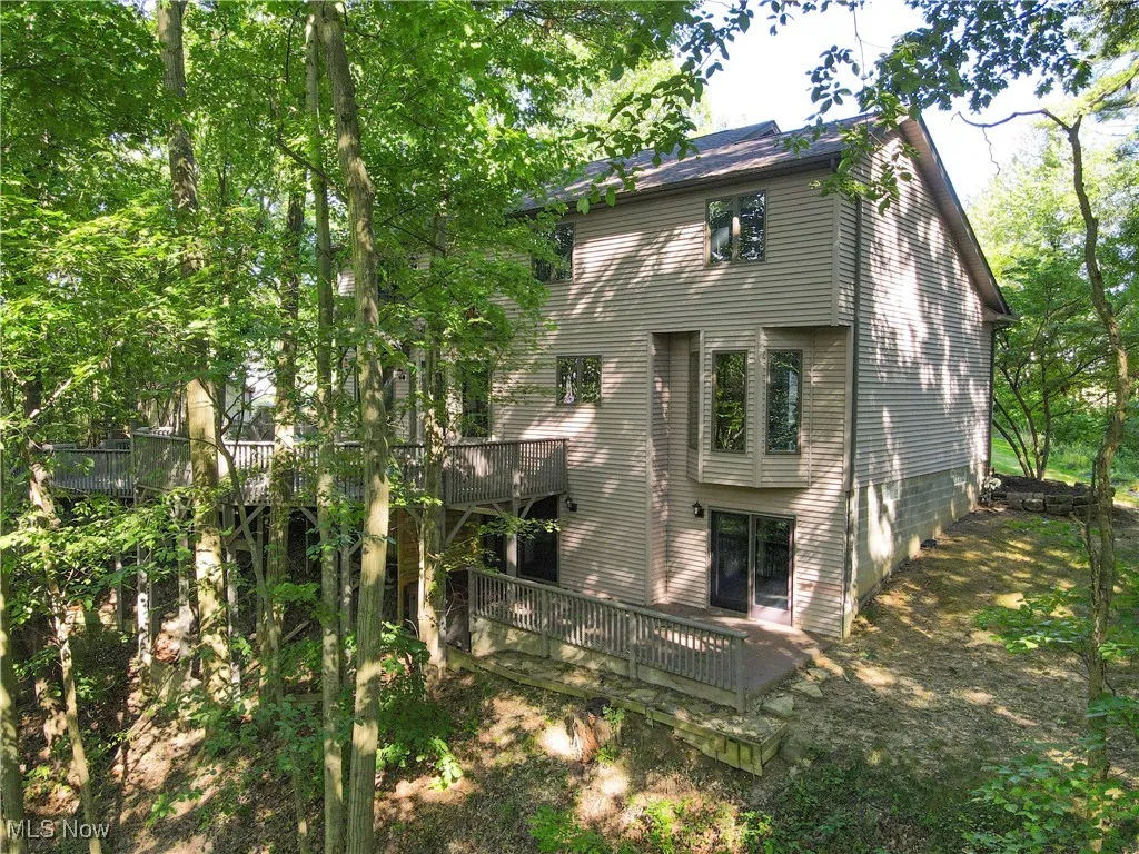 Rear view of house featuring a wooden deck