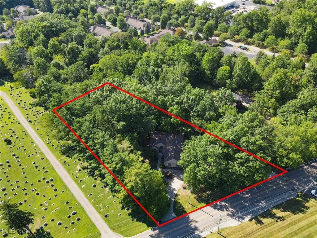 Aerial view of property and surrounding area with property parcel outlined