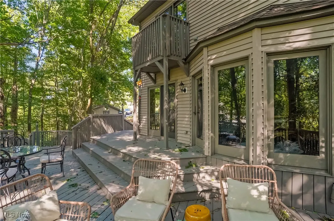 Deck featuring outdoor dining area and view of scattered trees
