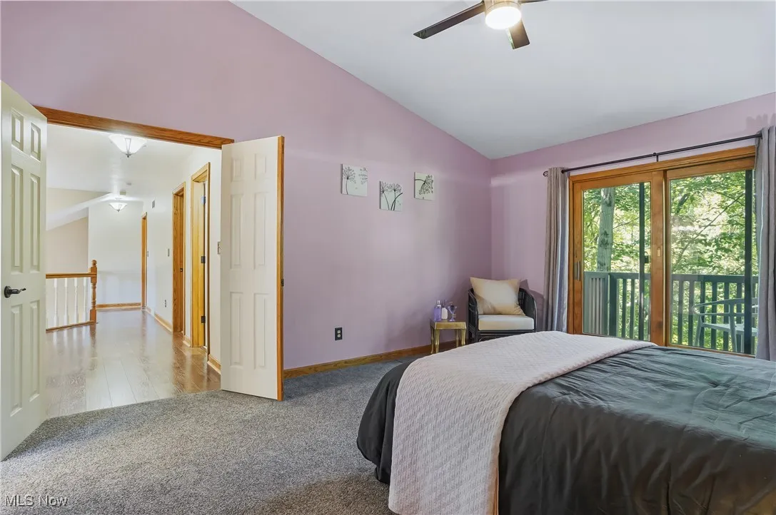 Bedroom with lofted ceiling, carpet flooring, access to outside, and ceiling fan