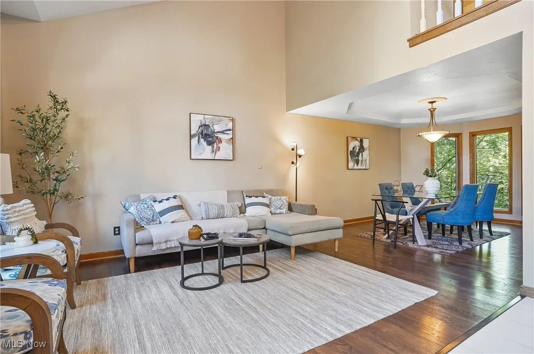 Living room with a towering ceiling and wood finished floors