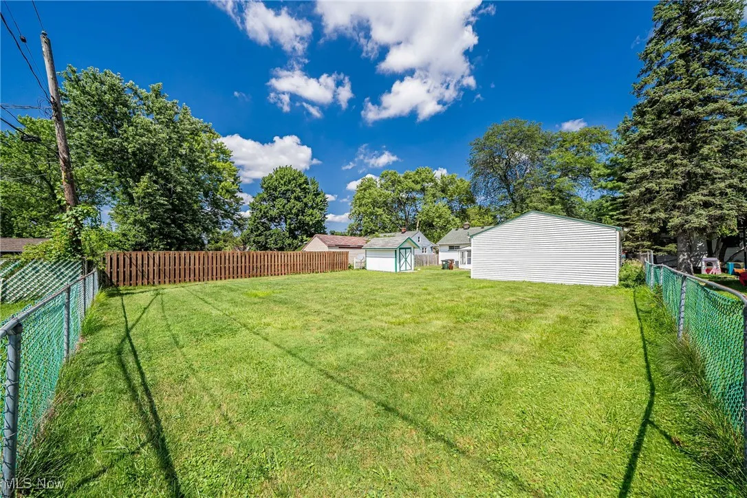Fenced backyard with a storage shed