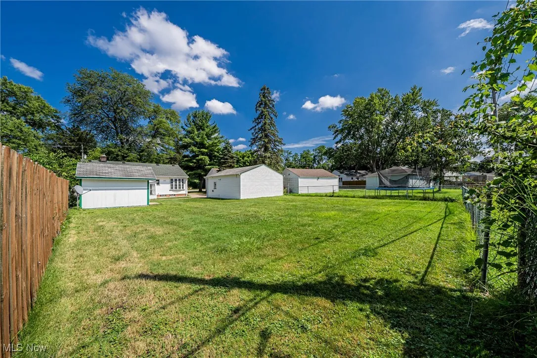Fenced backyard with an outbuilding