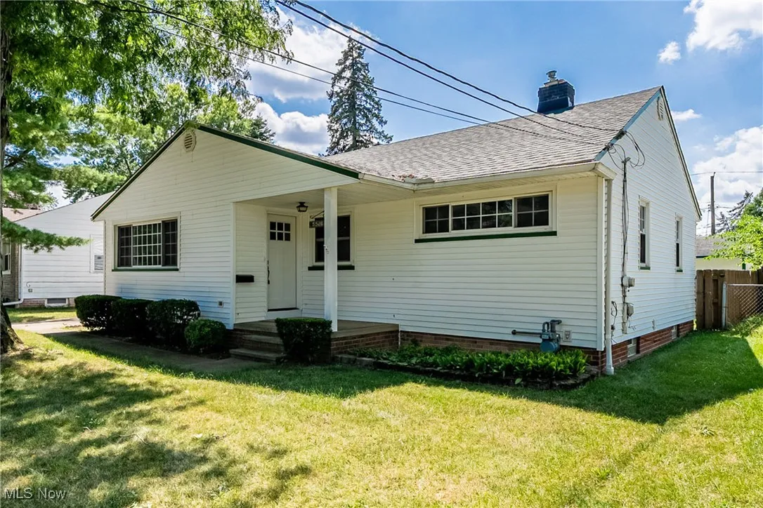 View of front of property with roof with shingles and a chimney