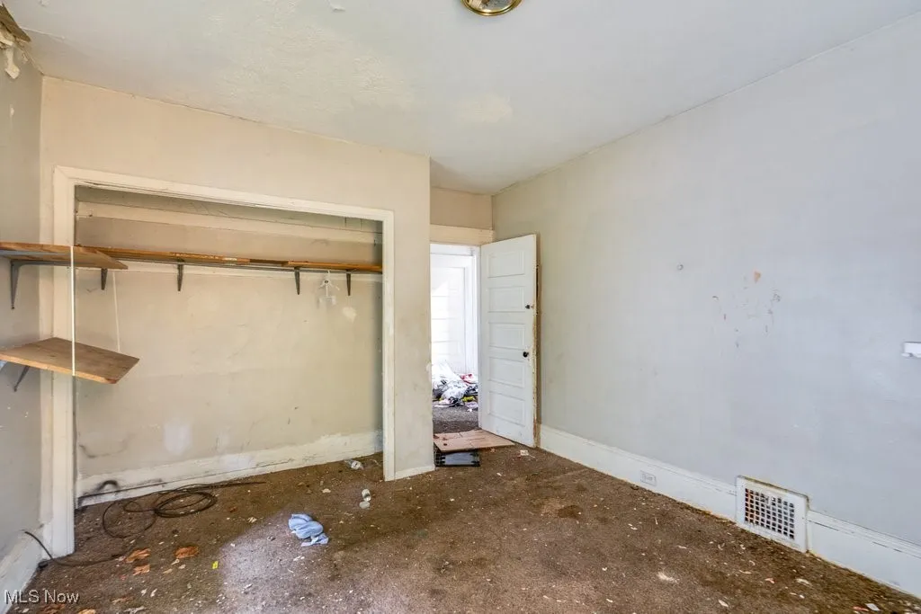 Unfurnished bedroom with baseboards and a closet