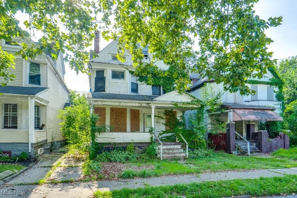 View of front of home with covered porch and a chimney
