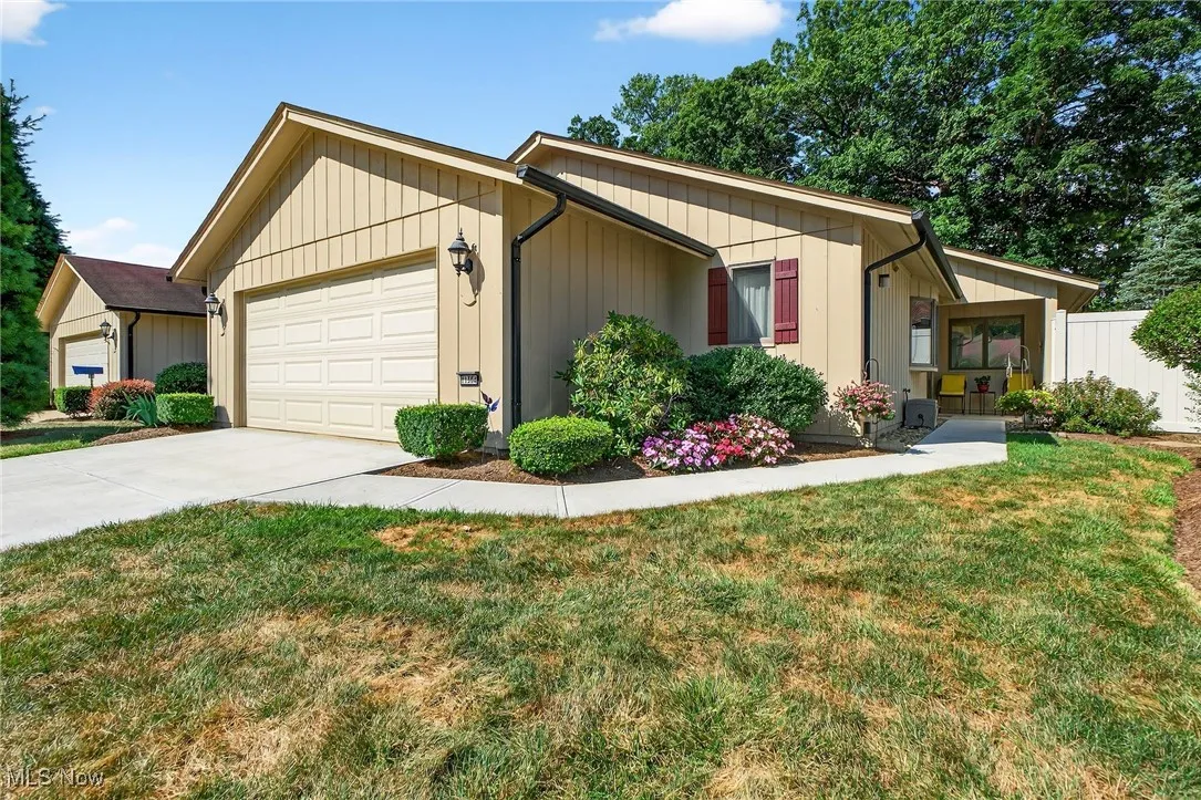 View of front of house featuring an attached garage and newer driveway