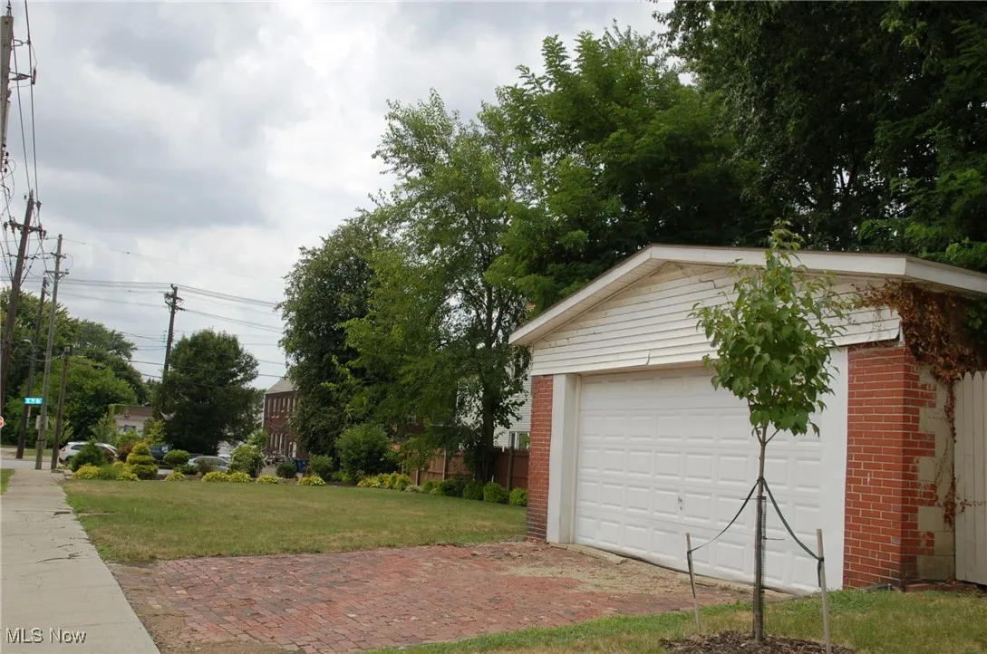 Full view of spacious lot includes 2 car garage--door and roof has been replaced-brick paver driveway. Great area bordering Cuyahoga Hts. Water,  Electric , Gas, and Sewer available
