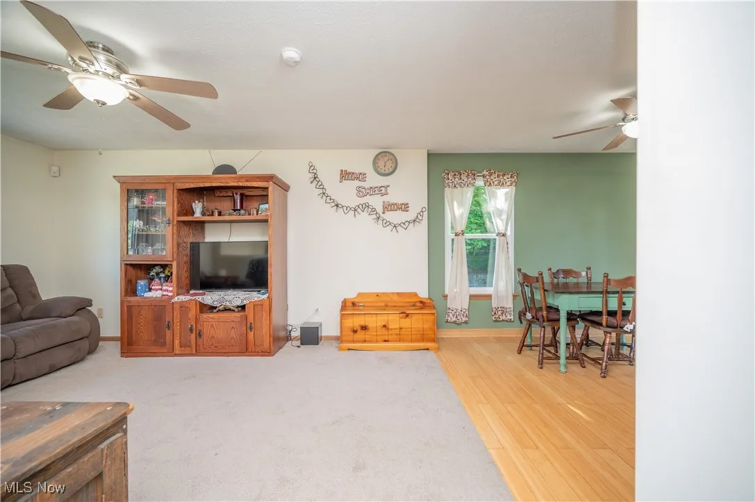 Living room featuring ceiling fan and light wood-style flooring
