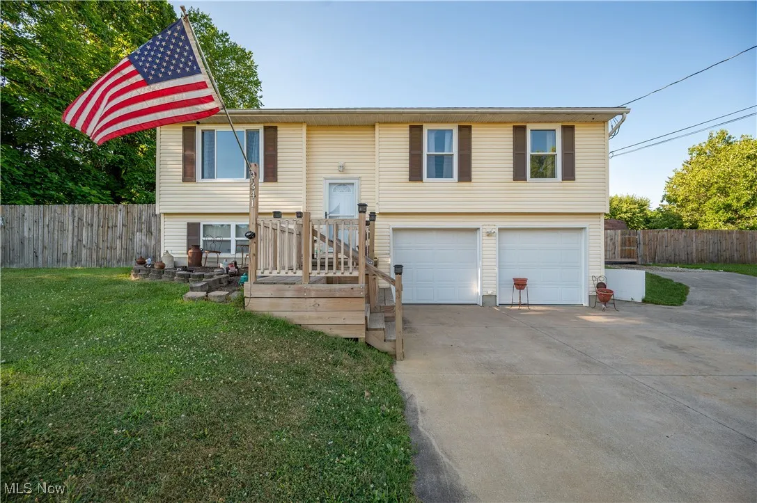 Bi-Level home with concrete driveway and an attached garage