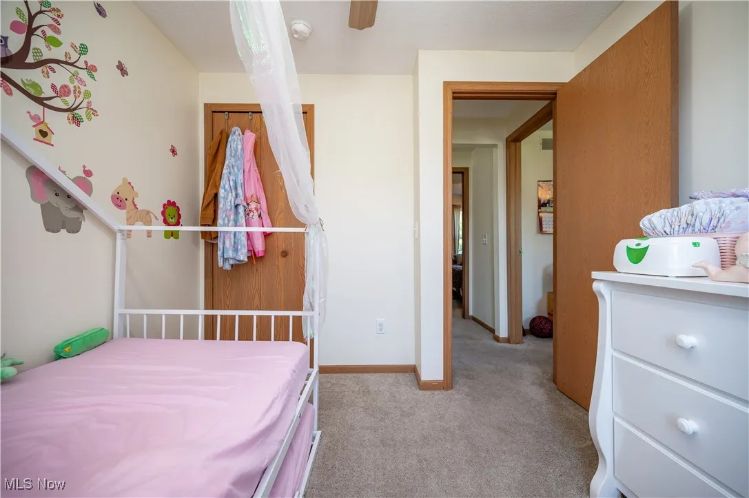 Bedroom featuring light carpet and ceiling fan