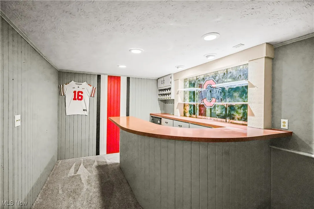 Bar area featuring a textured ceiling and carpet
