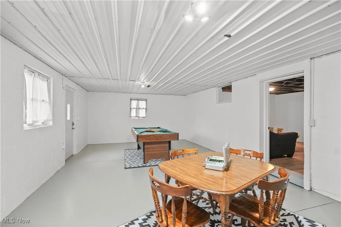 Dining room with finished concrete floors and billiards