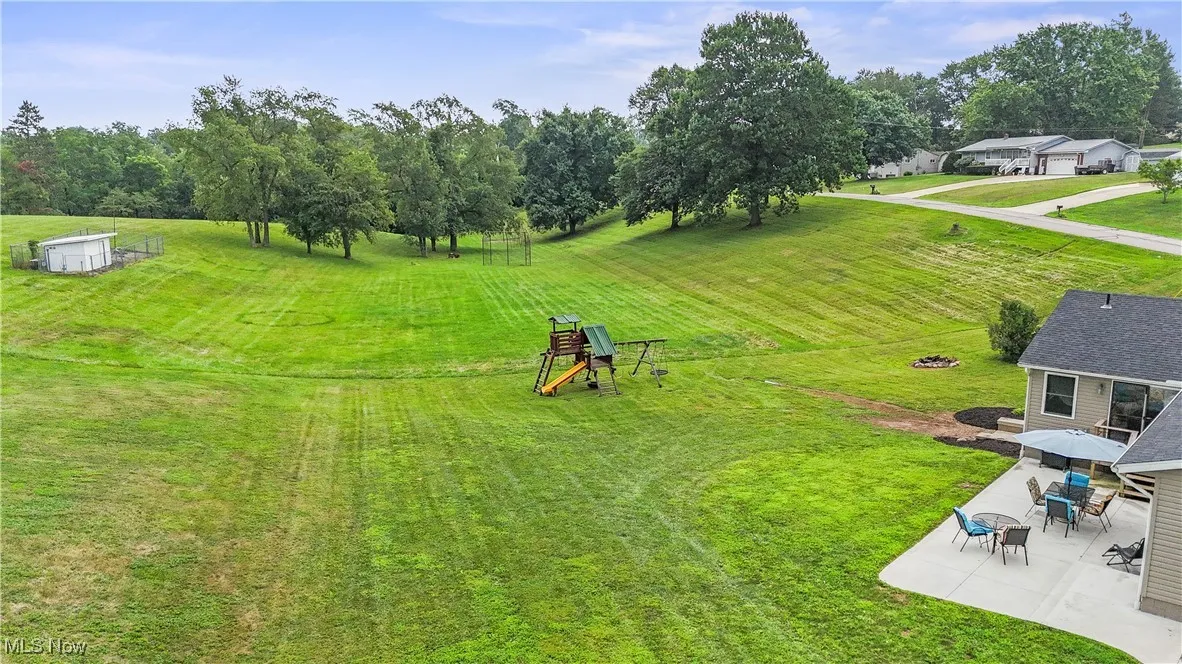 View of grassy yard featuring a patio and a gazebo