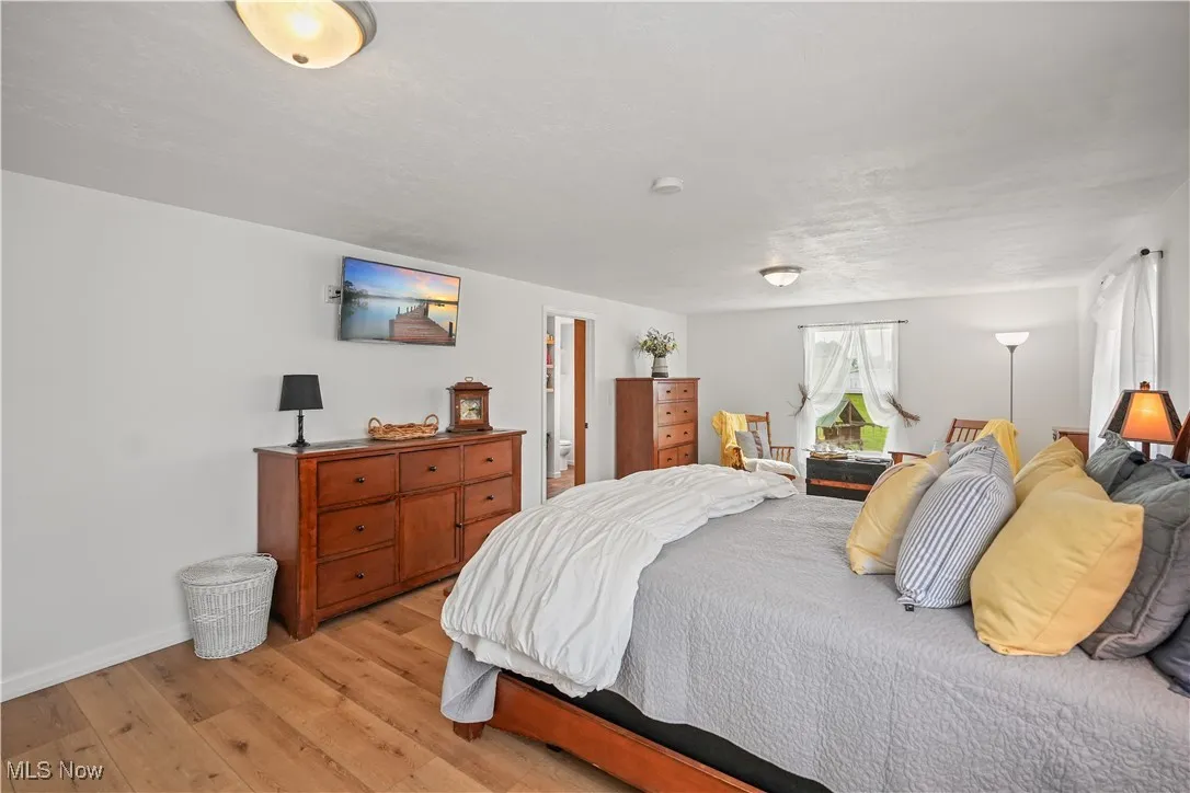 Bedroom featuring light wood finished floors and baseboards