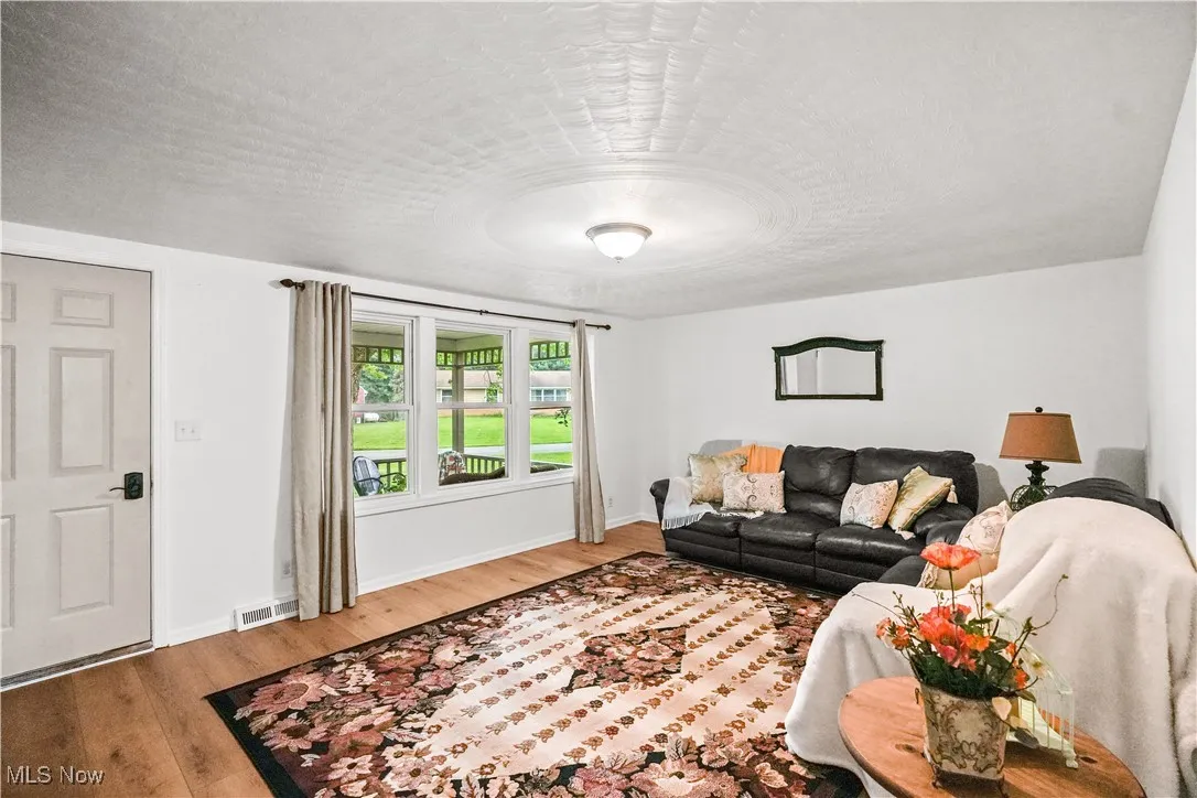 Living room featuring wood finished floors and a textured ceiling
