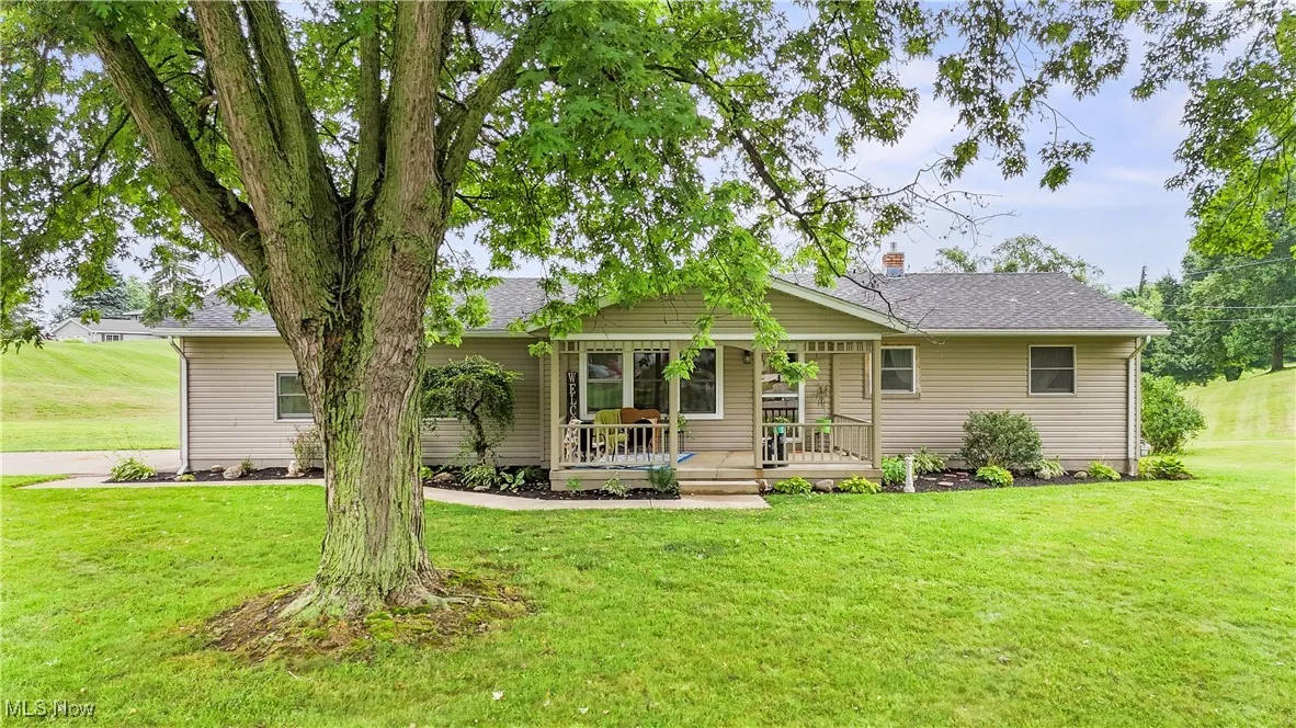 Ranch-style house featuring a front yard and a shingled roof
