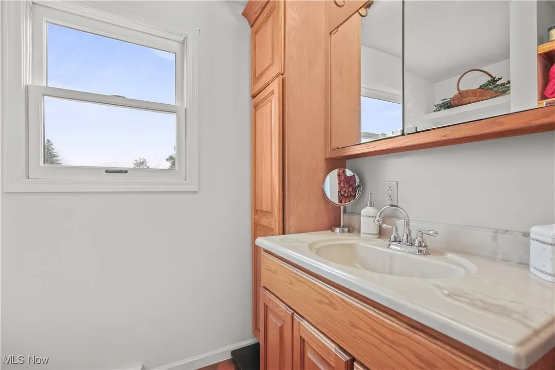 Bathroom featuring vanity and baseboards