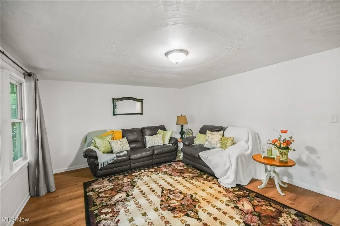 Living area with a textured ceiling and wood finished floors