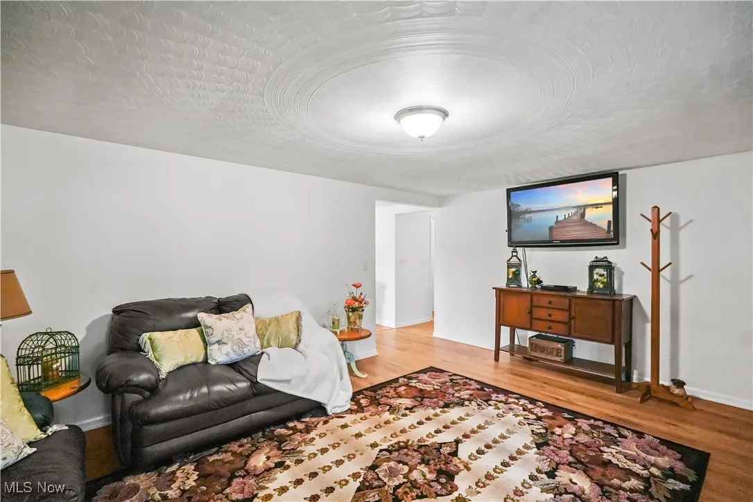 Living room featuring a textured ceiling and light wood-type flooring