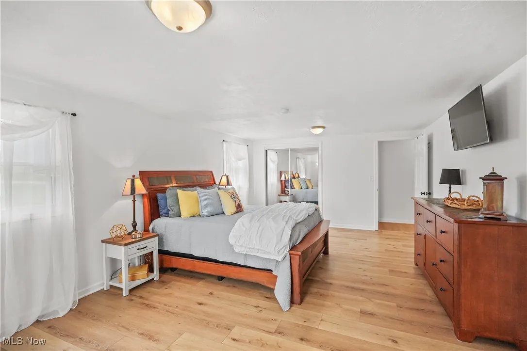 Bedroom featuring light wood-type flooring and baseboards