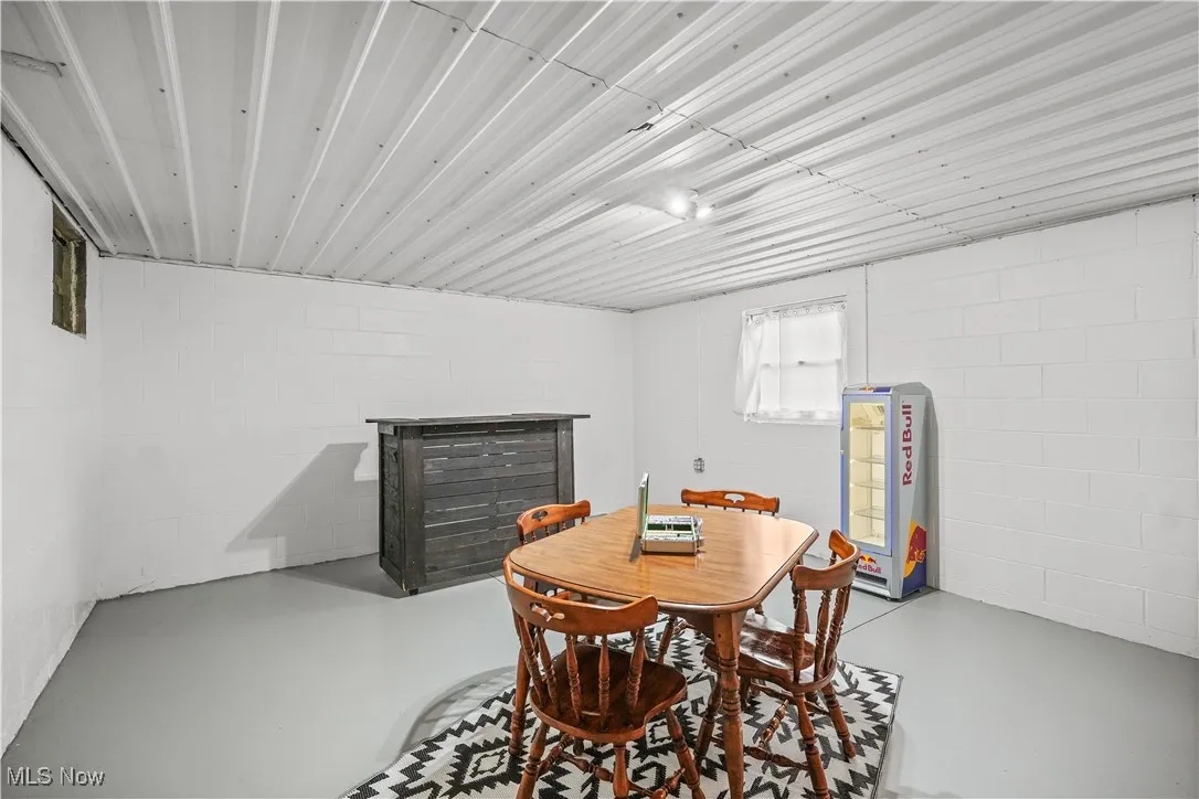 Dining room featuring finished concrete floors and concrete block wall