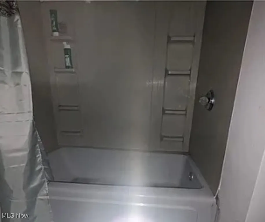 Bathroom with shower / tub combo with curtain