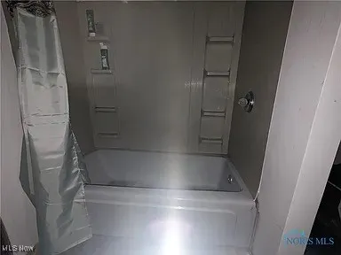 Bathroom featuring shower / bath combo with shower curtain