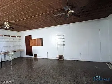 Garage with ceiling fan and an ornate ceiling