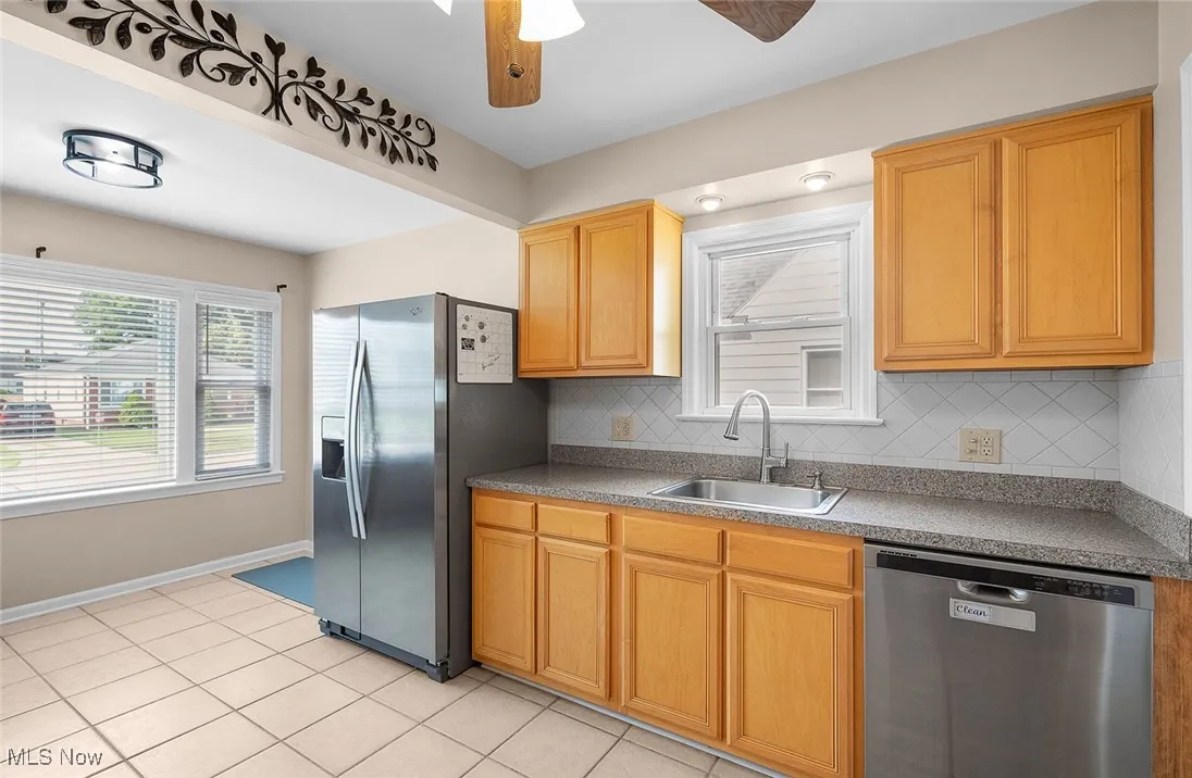 Kitchen with maple cabinets and ceramic tile floor
