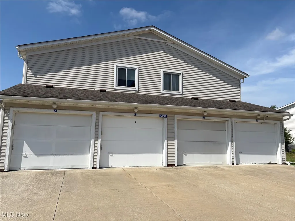 Garage featuring concrete driveway