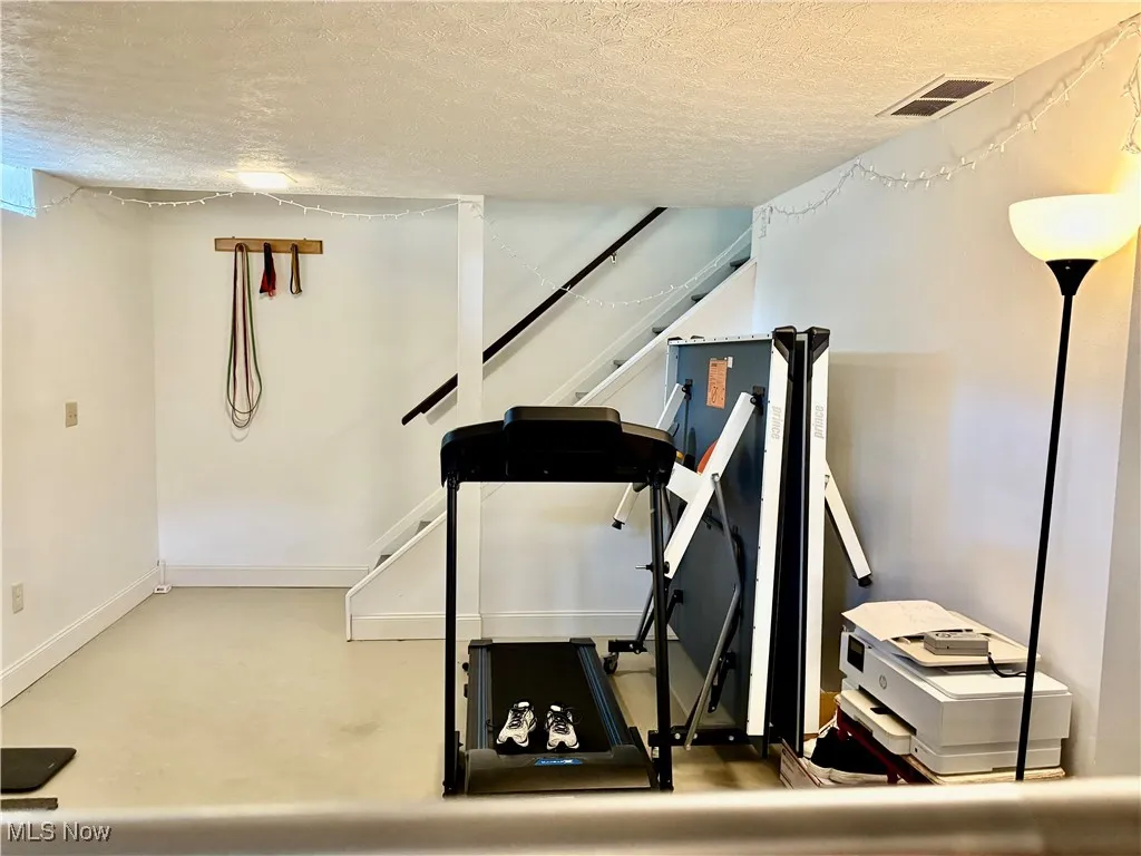 Basement rec room has finished walls and ceiling. Just needs the flooring