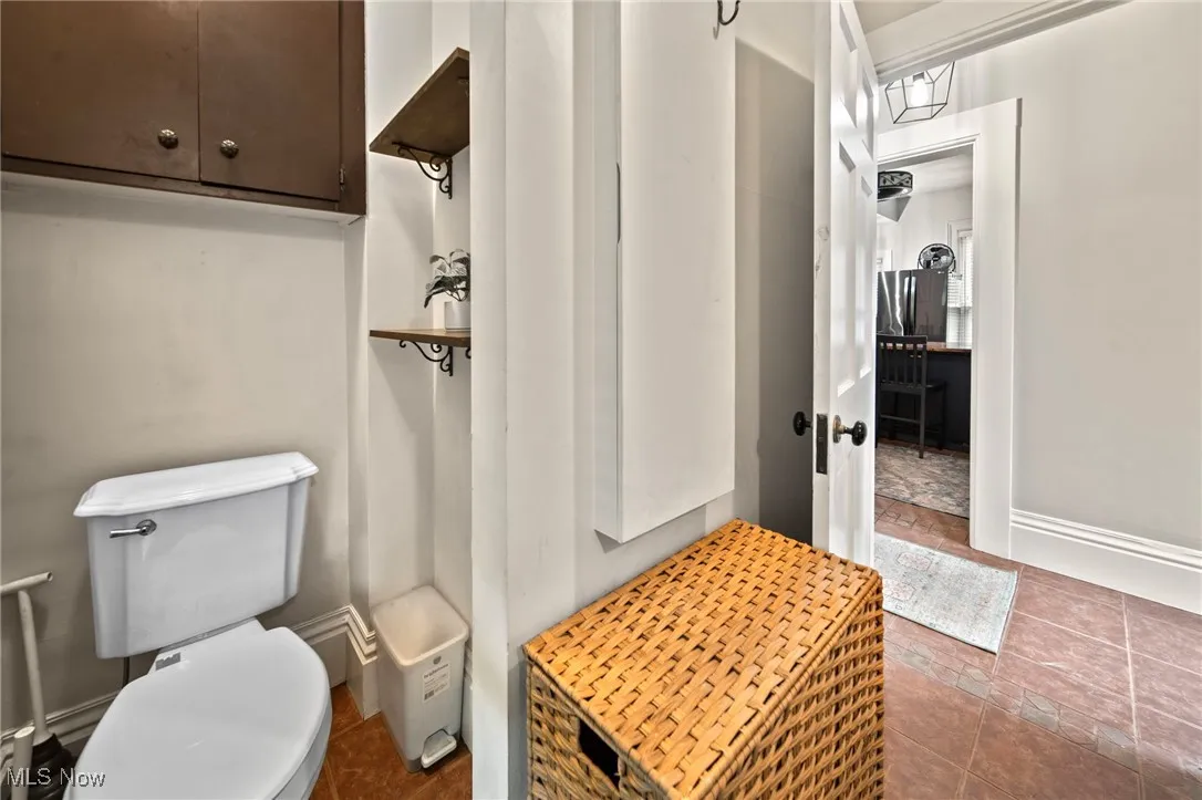 Bathroom with toilet and tile patterned flooring