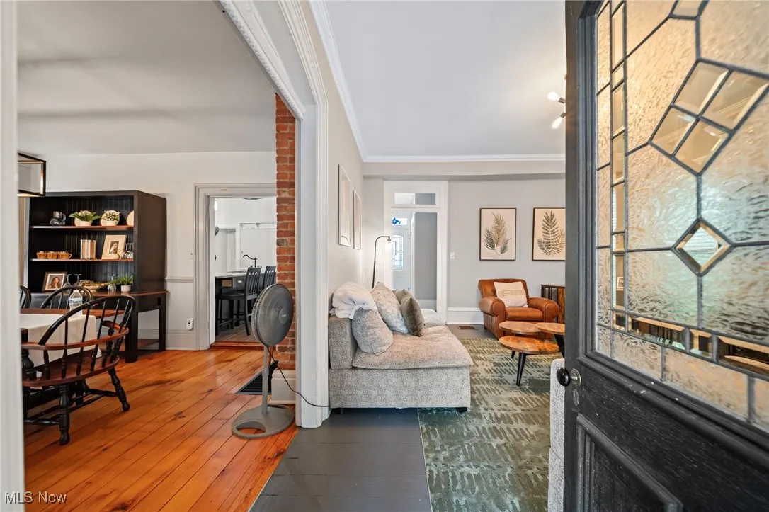 Living room featuring hardwood / wood-style floors and crown molding