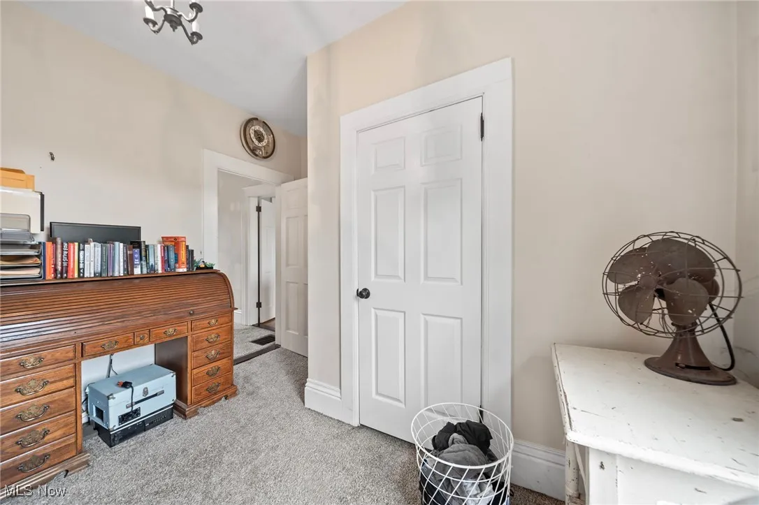Home office featuring carpet and baseboards