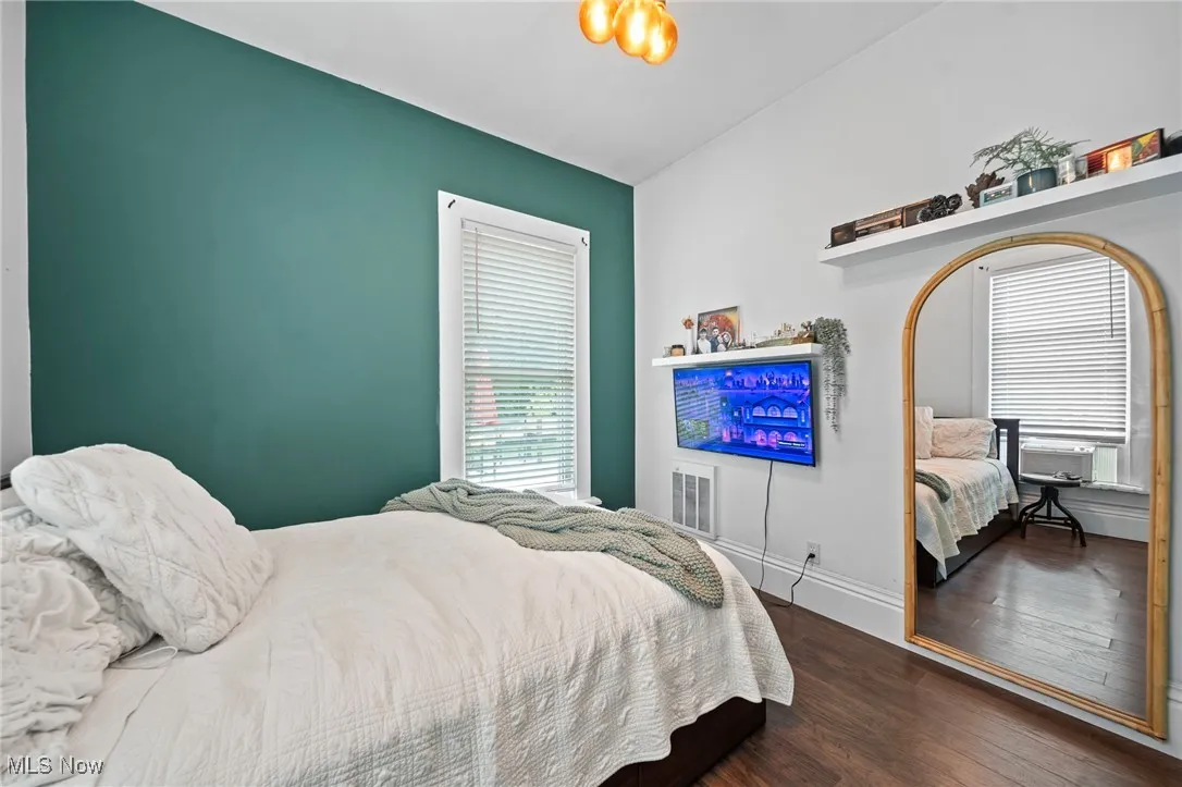 Bedroom featuring wood finished floors and baseboards