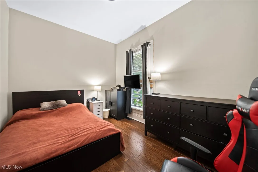 Bedroom with dark wood-type flooring