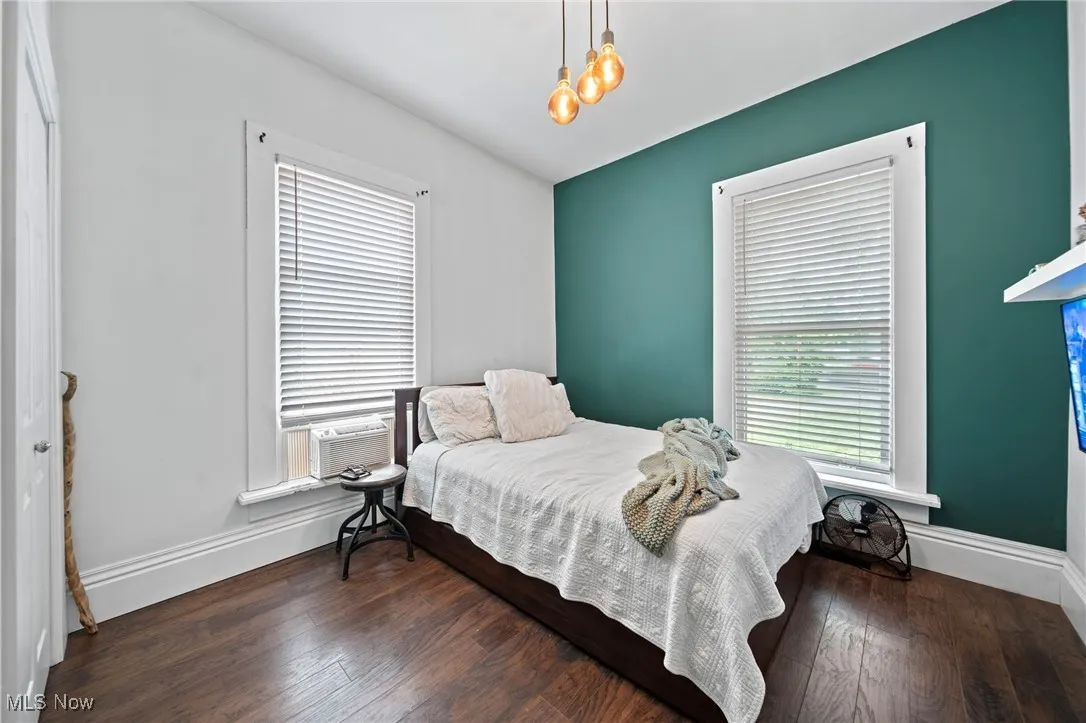 Bedroom featuring baseboards and wood finished floors