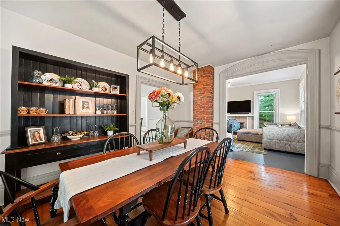 Dining area with hardwood / wood-style flooring and a fireplace