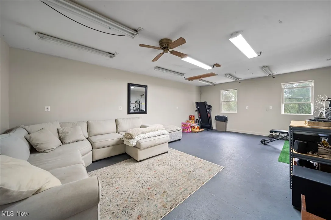 Living room with concrete floors and ceiling fan