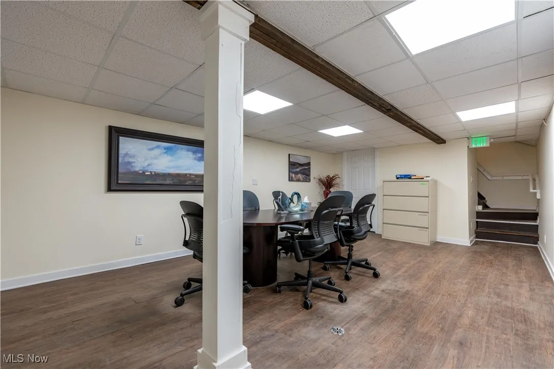 Office area featuring a paneled ceiling and hardwood / wood-style floors