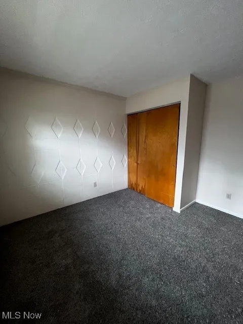 Unfurnished bedroom with carpet