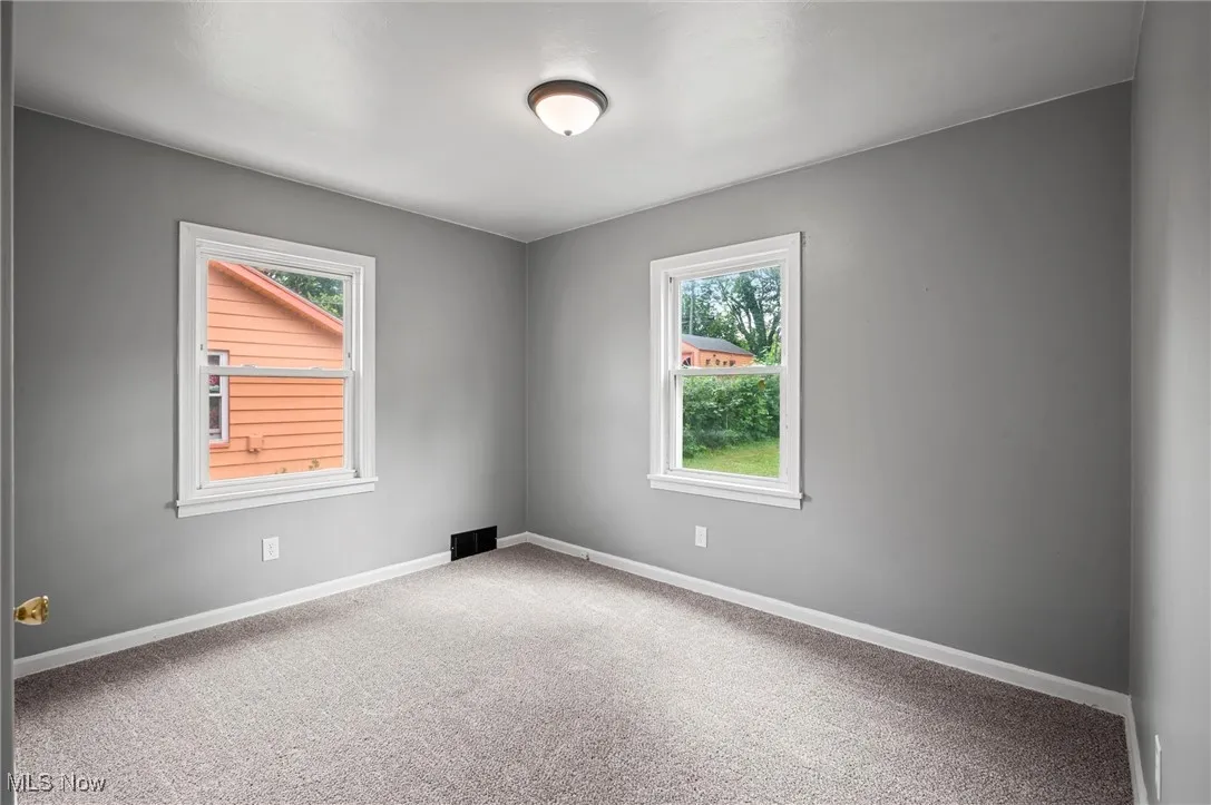 Bedroom 1 with carpet flooring and baseboards
