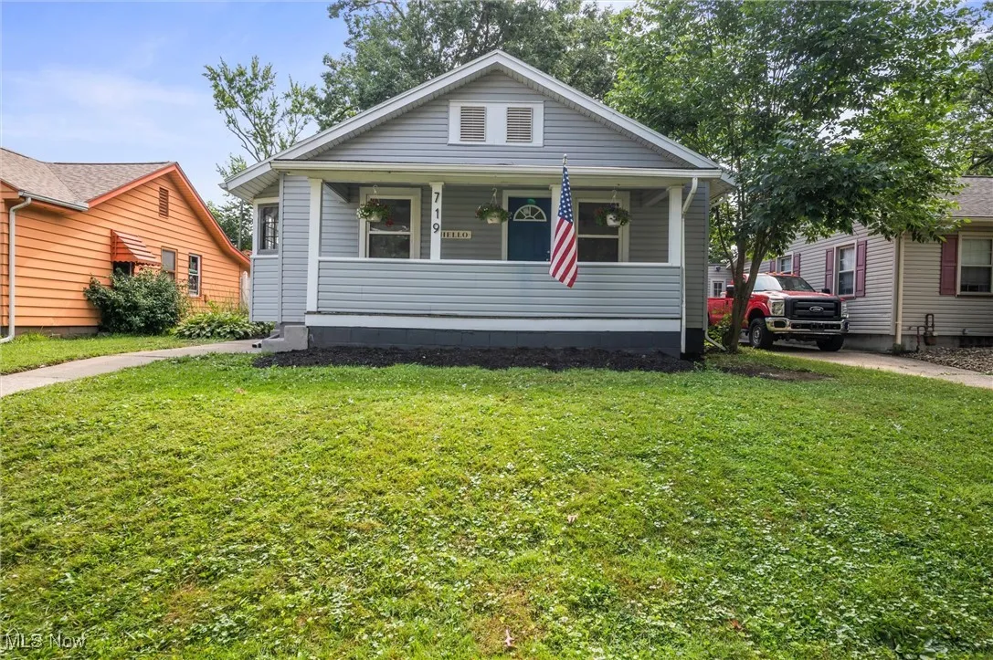 View of front of home featuring a front lawn and a porch